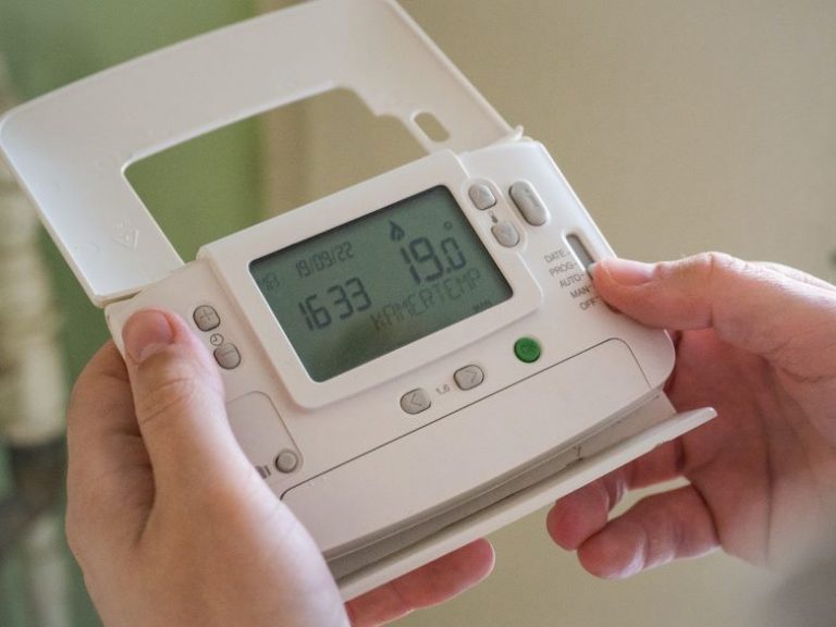 Digital thermostat in a home, helping control energy use for energy efficiency in UK houses